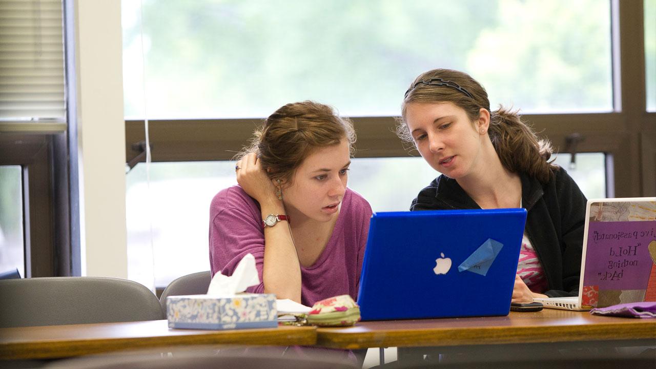 Two students using laptops